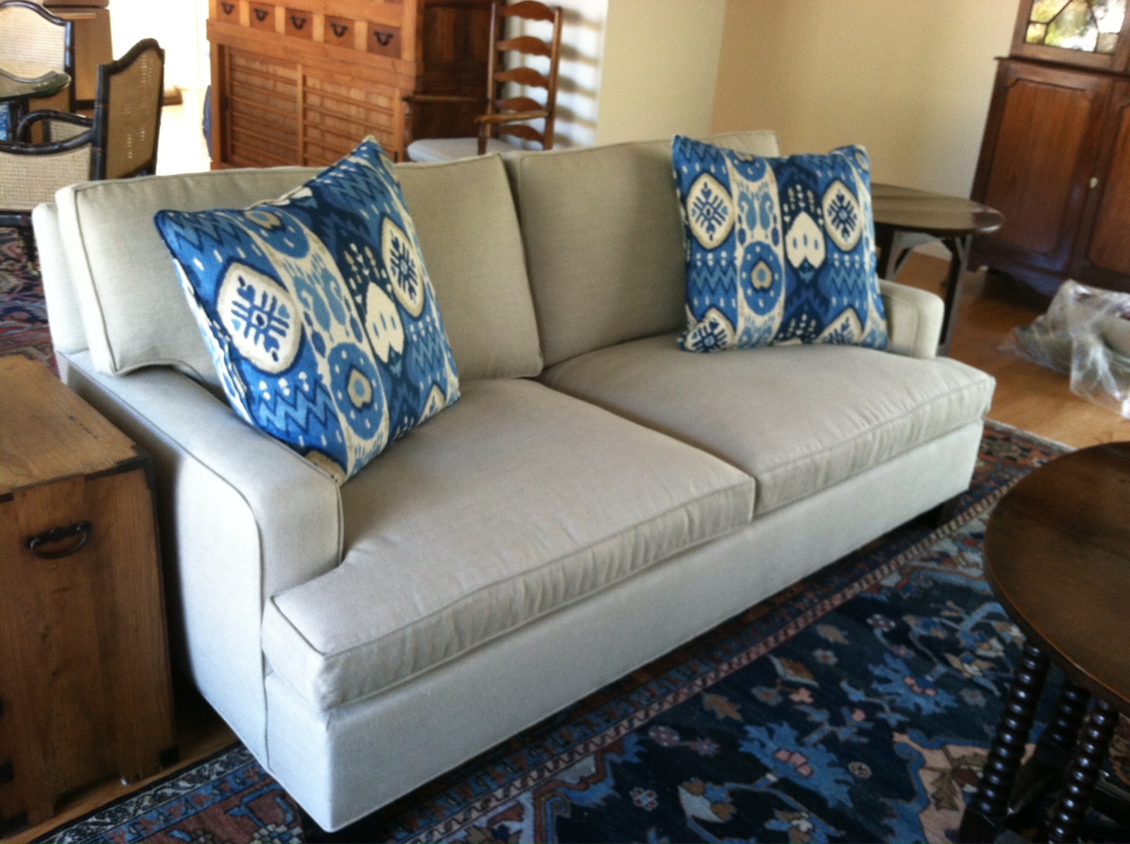 Original upholstered sofa with patterned blue cushions